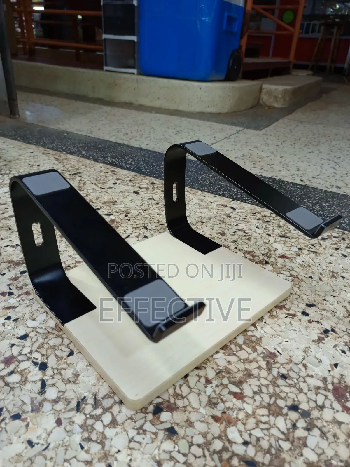 Portable Laptop Stand With a Wooden Base and Black Metal Frame.