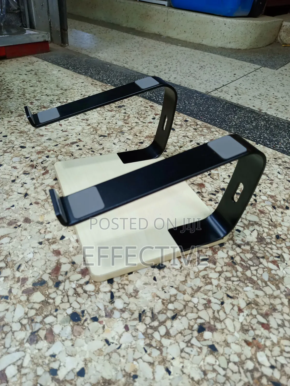 Portable Laptop Stand With a Wooden Base and Black Metal Frame.