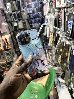 A Clear Protective Phone Case With a Blue, Pink, and Gold Marble Desi