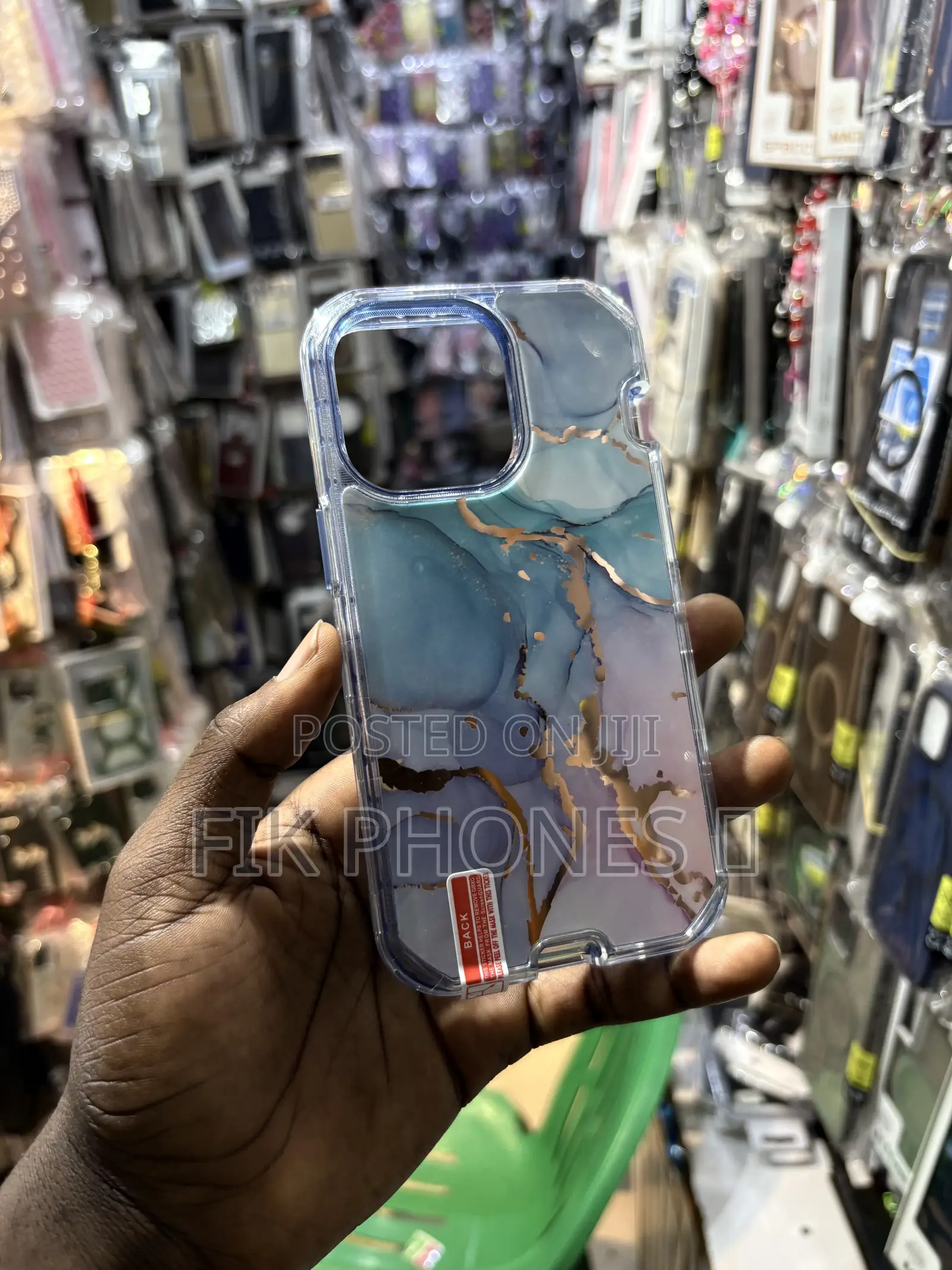 A Clear Protective Phone Case With a Blue, Pink, and Gold Marble Desi
