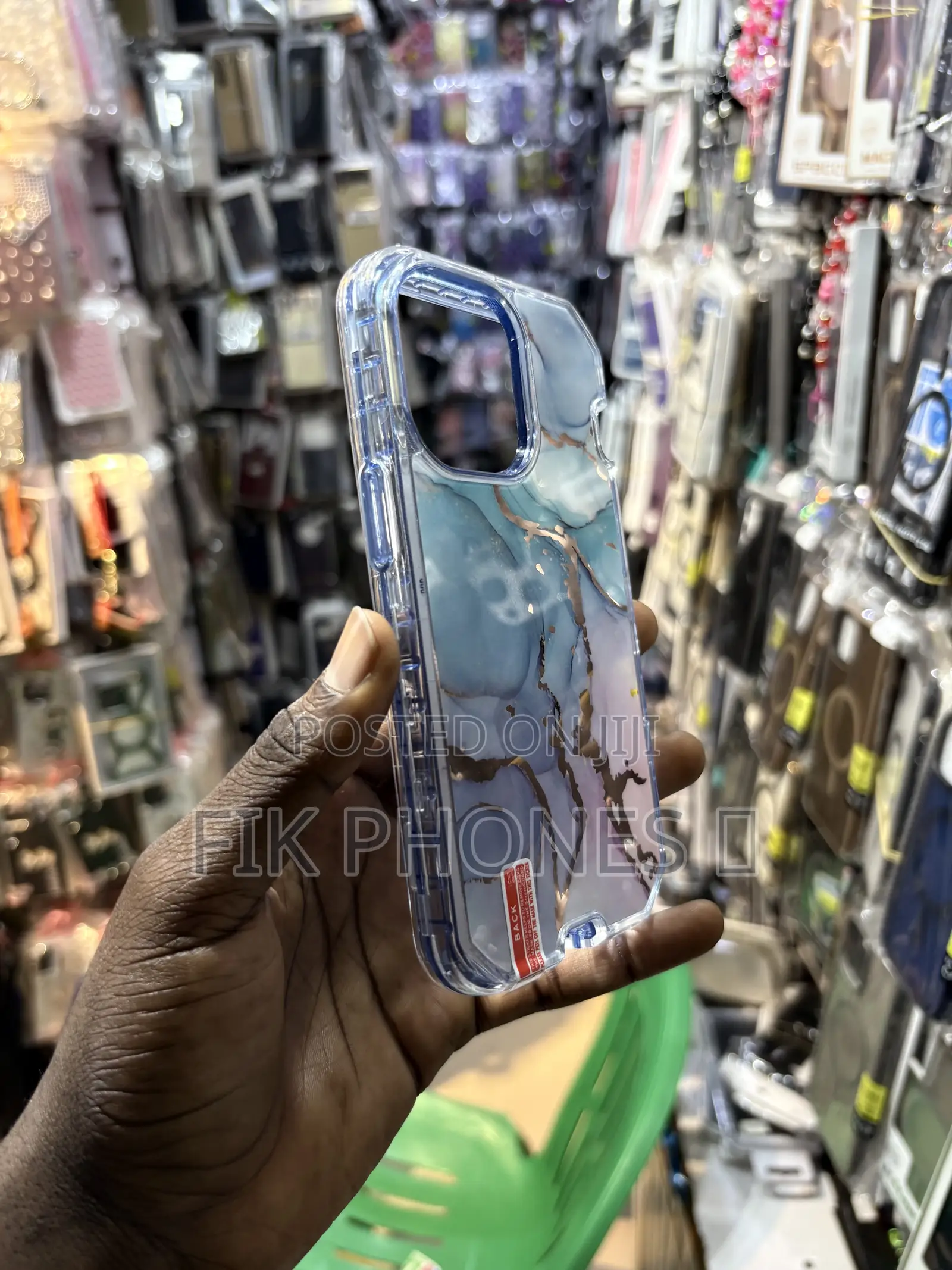 A Clear Protective Phone Case With a Blue, Pink, and Gold Marble Desi