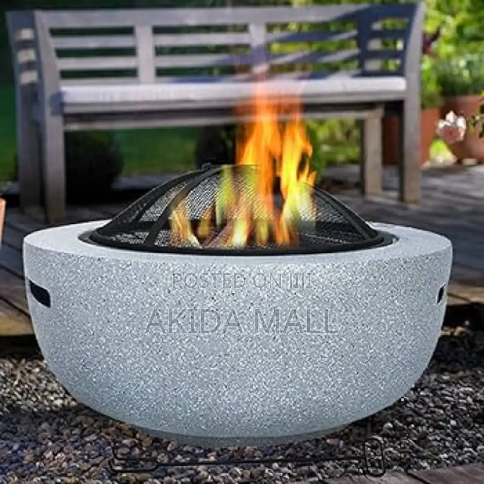 Round Outdoor Fire Pit With a Speckled Artificial Stone Surround