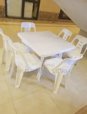 A Set of White Plastic Chairs and a Matching Plastic Table