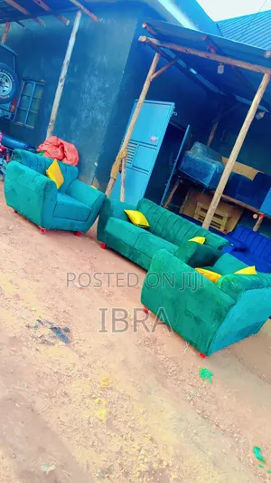 A Green Sofa Set With a Yellow Colored Pillows