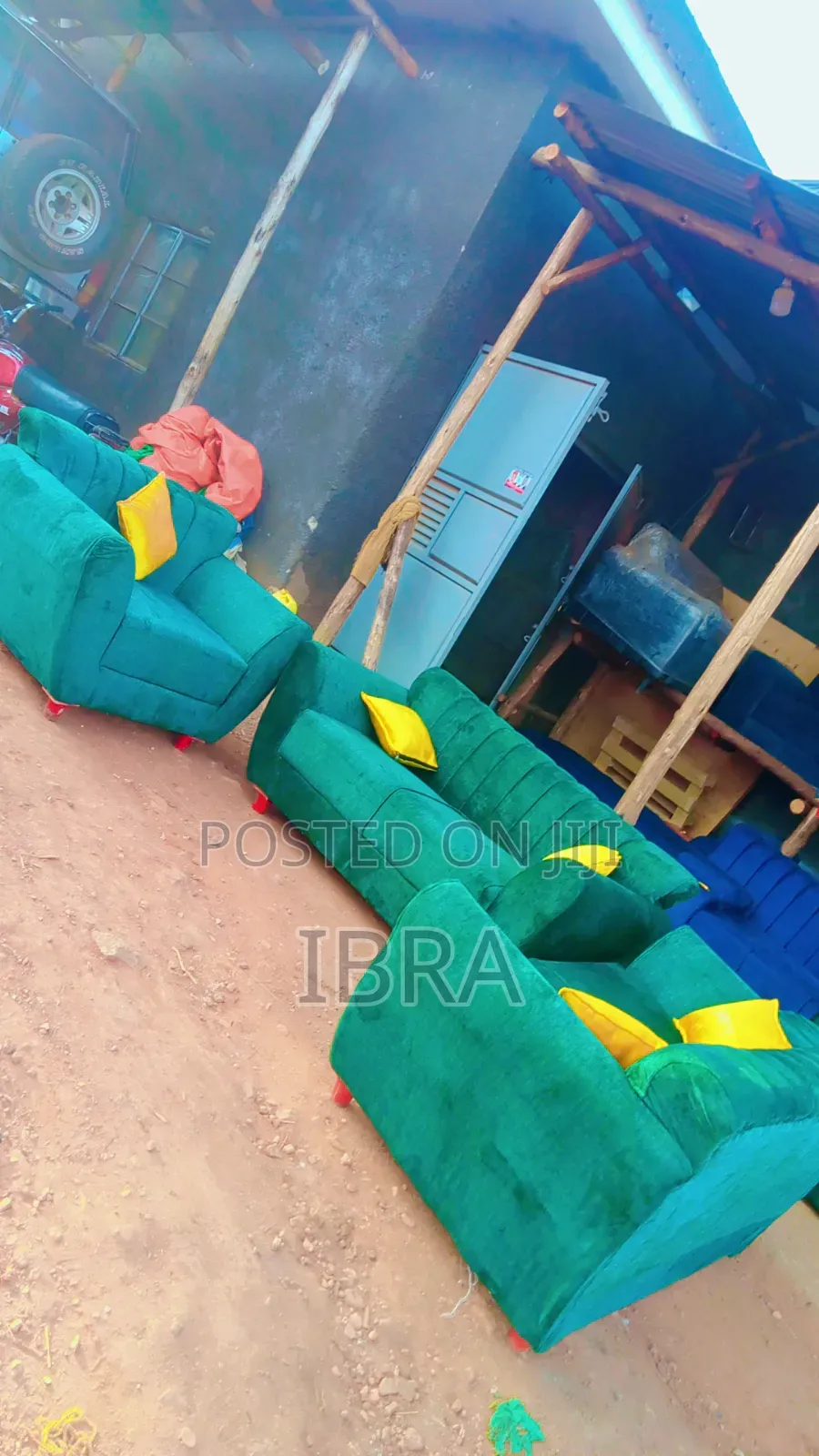 A Green Sofa Set With a Yellow Colored Pillows