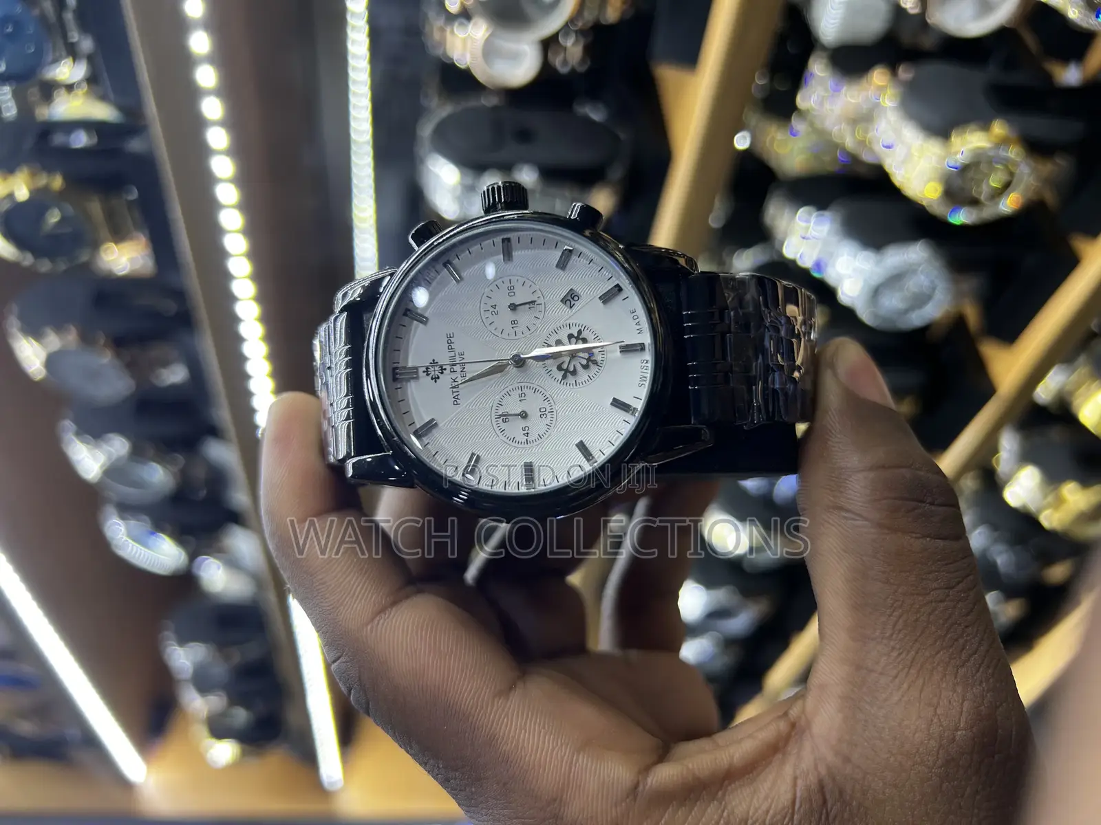 Black Mens Patek Phillipe Watch With a White Dail