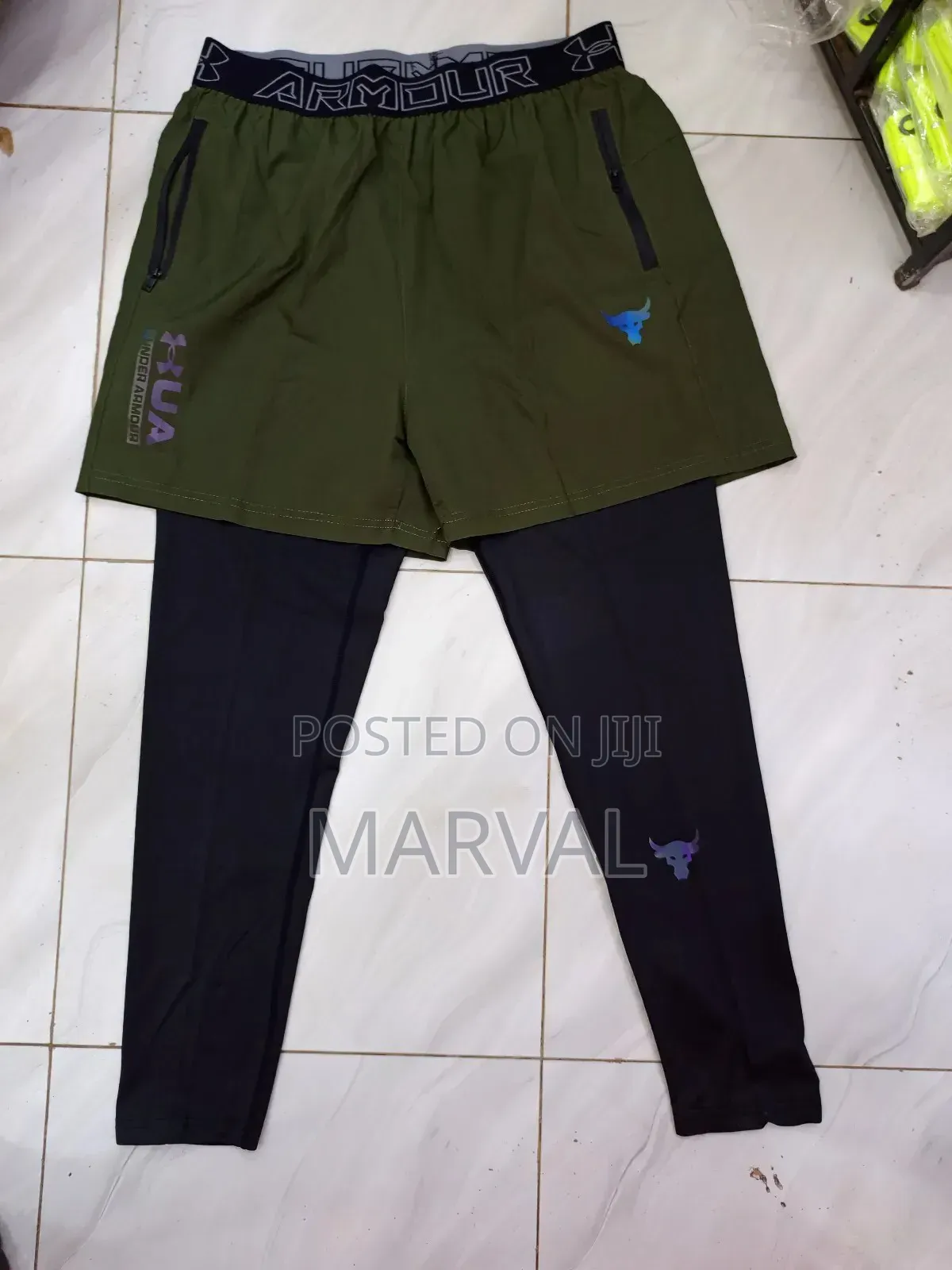 A Pair of Black and Olive Green Under Armour Athletic Pants.