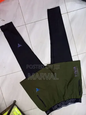 A Pair of Black and Olive Green Under Armour Athletic Pants.