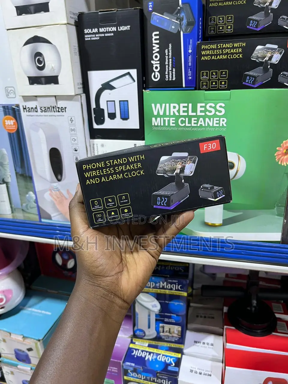A Phone Stand With Wireless Speakers and Alarm Clock