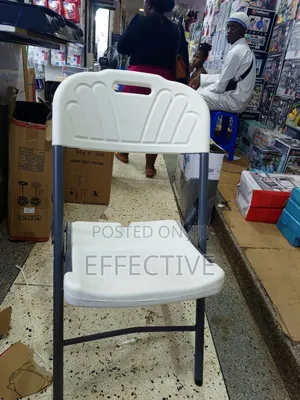 Plastic Folding Chair With a Grey Metal Frame.