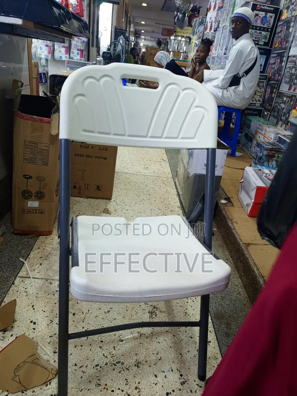 Plastic Folding Chair With a Grey Metal Frame.