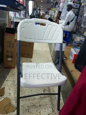 Plastic Folding Chair With a Grey Metal Frame.
