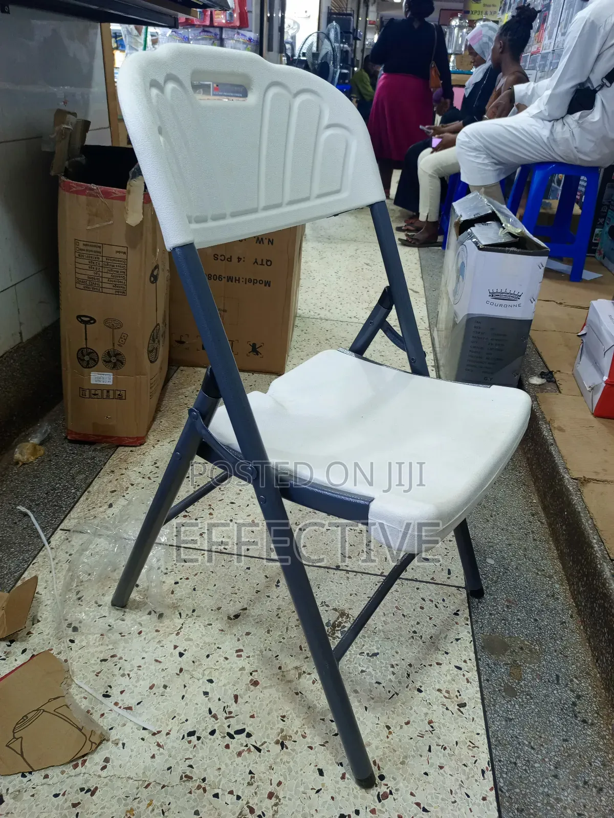 Plastic Folding Chair With a Grey Metal Frame.
