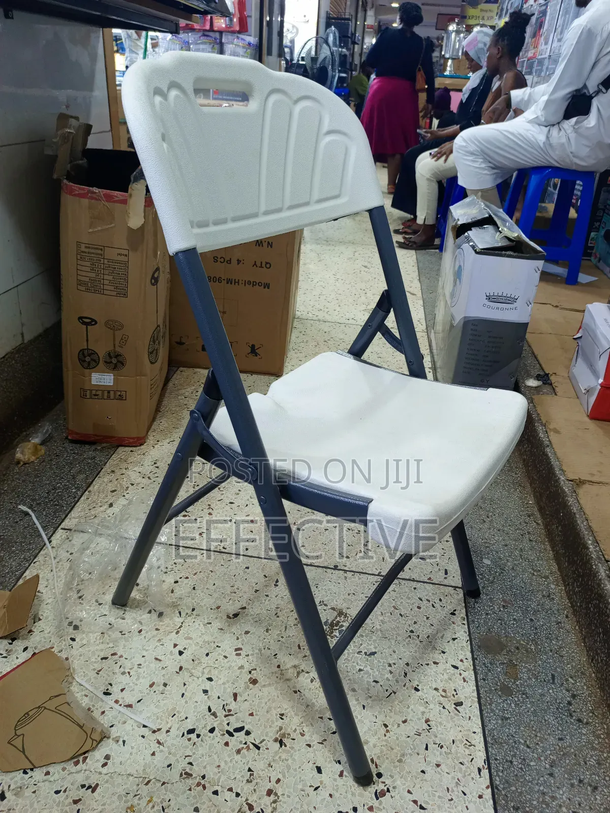 Plastic Folding Chair With a Grey Metal Frame.