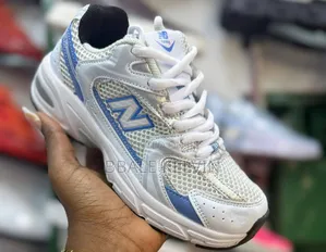 New Balance 530 Sneaker in White With Light Blue and Silver Accents