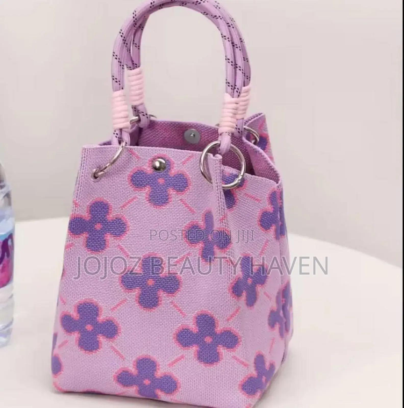 Knitted Bucket Bag With a Purple Flower Pattern.