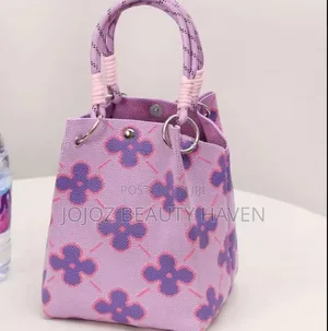 Knitted Bucket Bag With a Purple Flower Pattern.