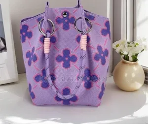 Knitted Bucket Bag With a Purple Flower Pattern.