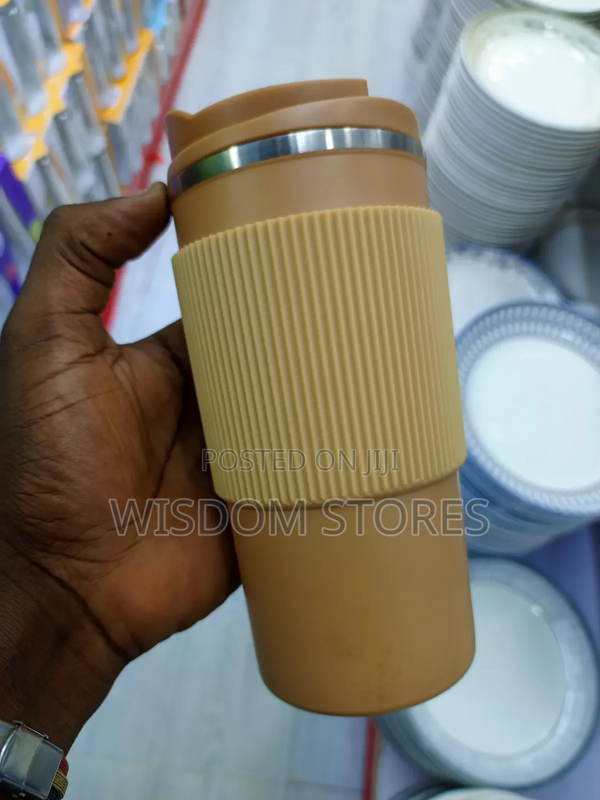 Insulated Travel Coffee Mug With a Lid and a Silicone Grip Sleeve.