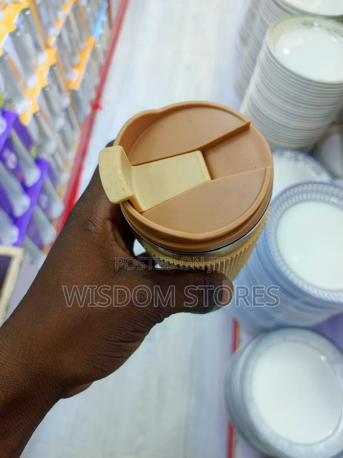 Insulated Travel Coffee Mug With a Lid and a Silicone Grip Sleeve.