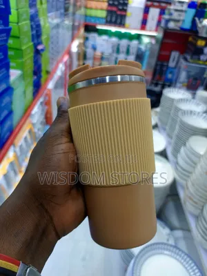 Insulated Travel Coffee Mug With a Lid and a Silicone Grip Sleeve.
