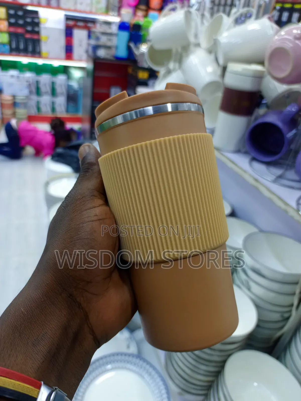 Insulated Travel Coffee Mug With a Lid and a Silicone Grip Sleeve.