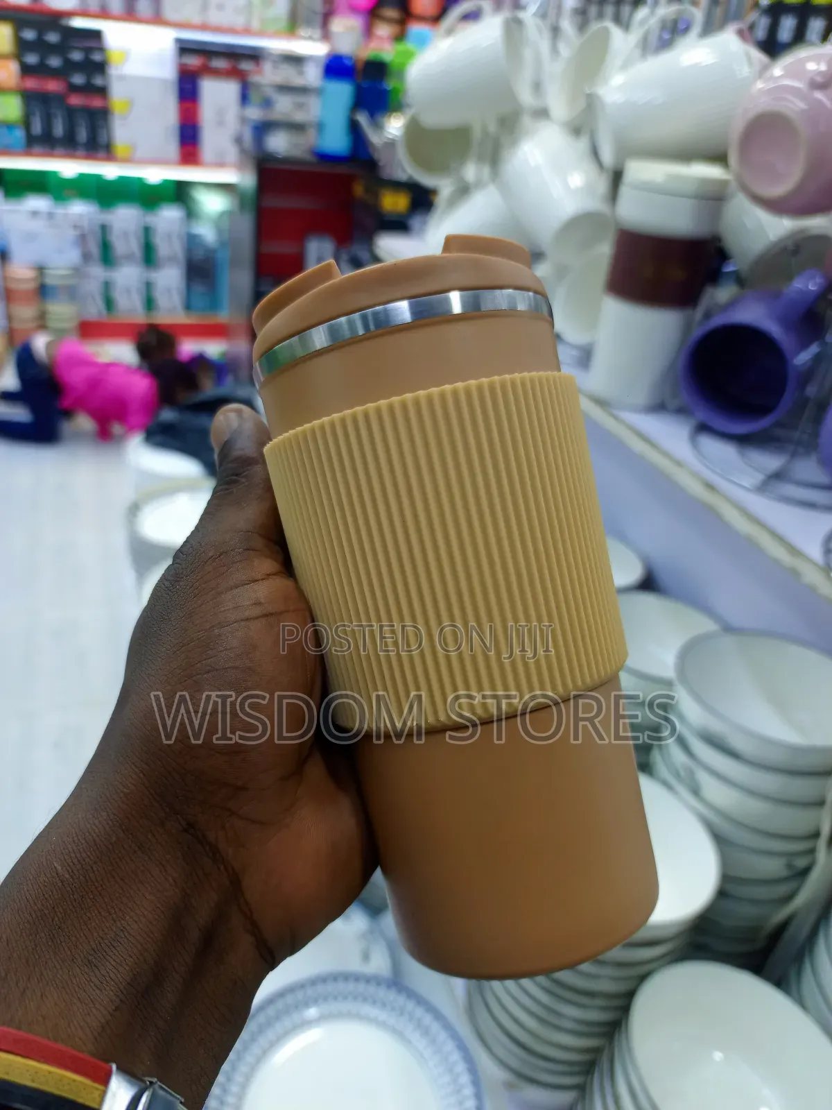 Insulated Travel Coffee Mug With a Lid and a Silicone Grip Sleeve.