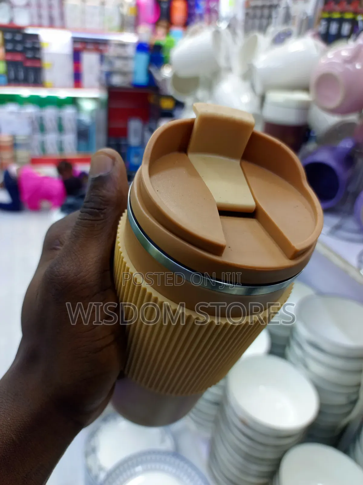 Insulated Travel Coffee Mug With a Lid and a Silicone Grip Sleeve.