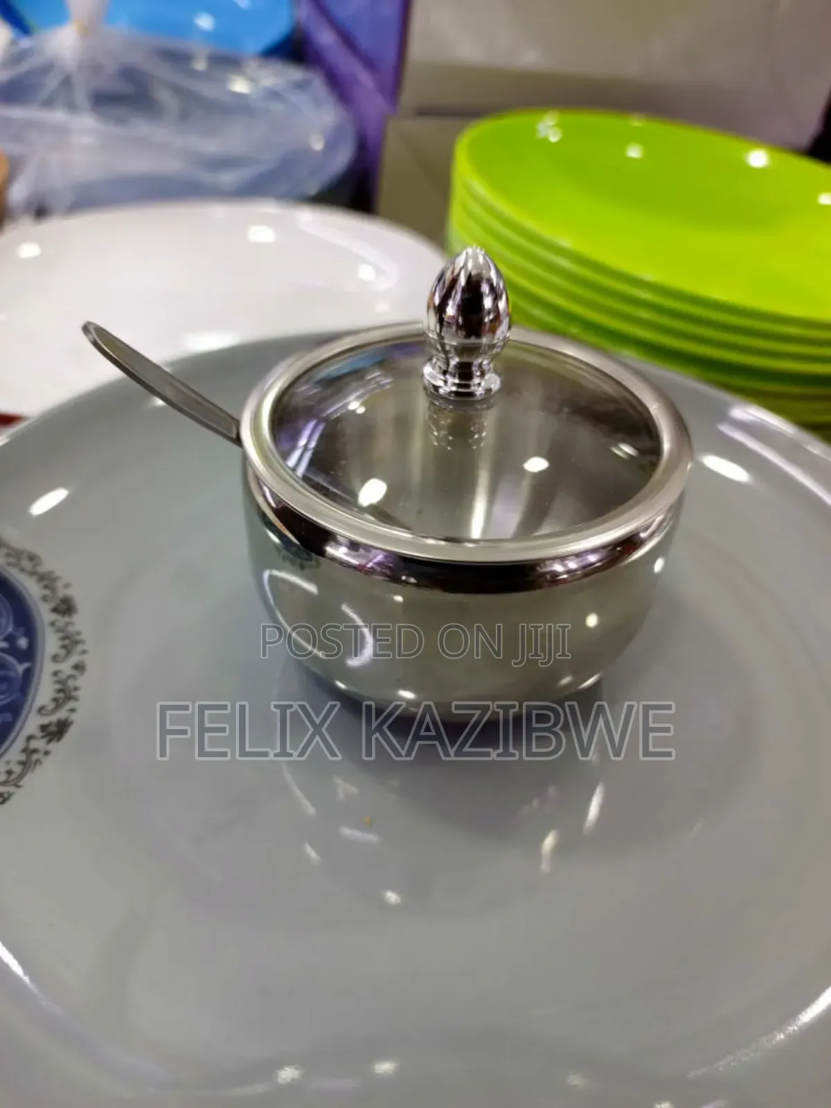 Stainless Steel Serving Pot With a Glass Lid and Spoon.