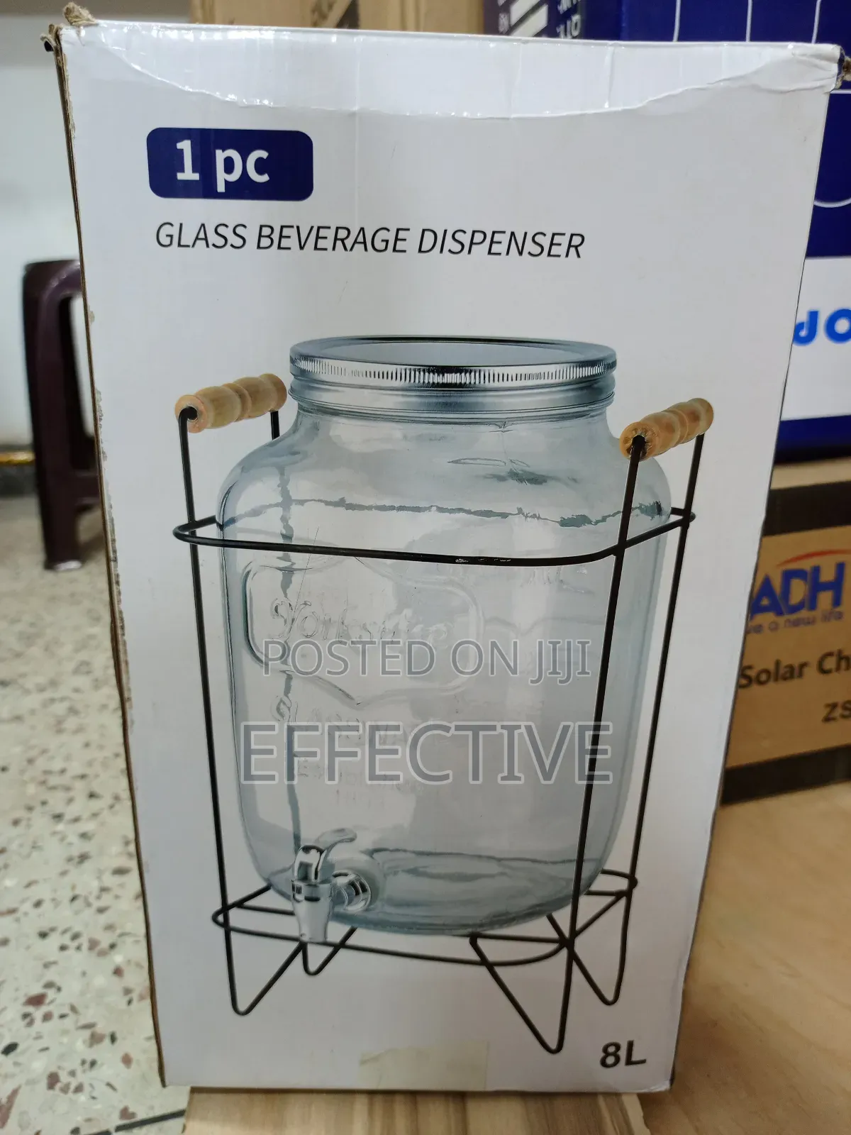 Glass Beverage Dispenser With a Metal Stand and Spigot.
