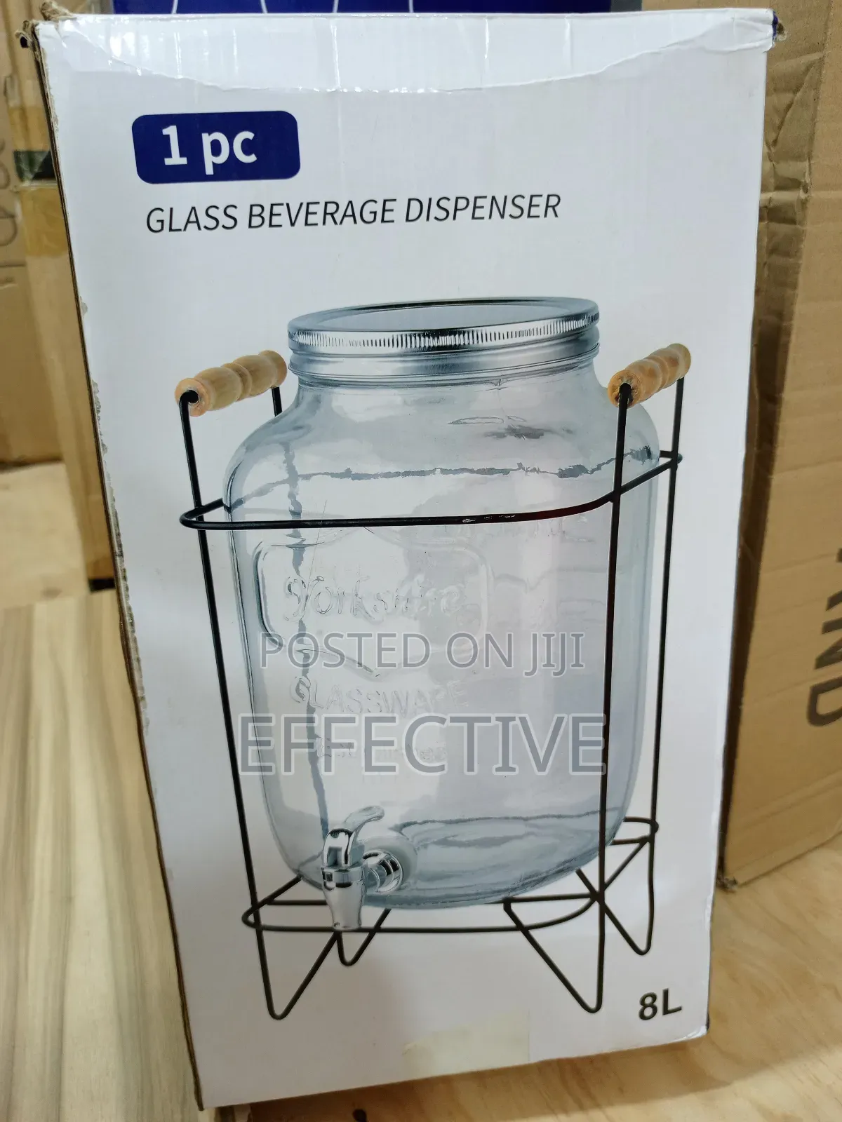 Glass Beverage Dispenser With a Metal Stand and Spigot.