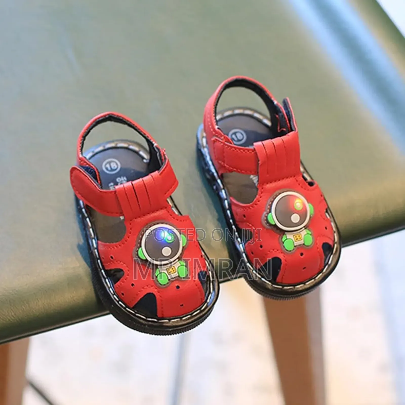 Babypro Brown Infant Squeaky Sandals With an Astronaut Design.