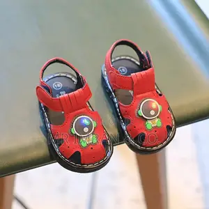 Babypro Brown Infant Squeaky Sandals With an Astronaut Design.