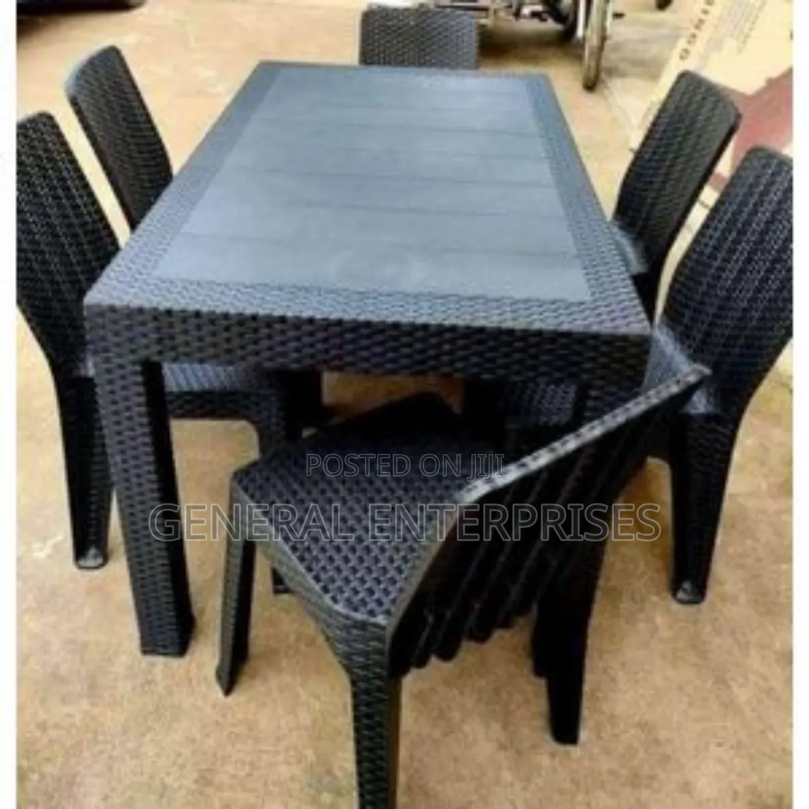 This Is a Black, Six-Seater Plastic Rattan Dining Set.