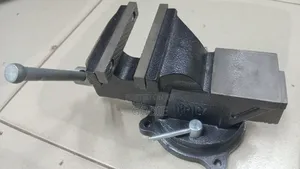Heavy-Duty Bench Vise Featuring a Swivel Base and a Built-in Anvil.