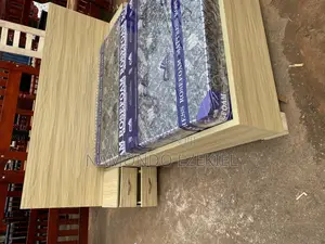 A Bed With Bedside Table and Mattress