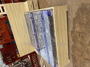 A Bed With Bedside Table and Mattress
