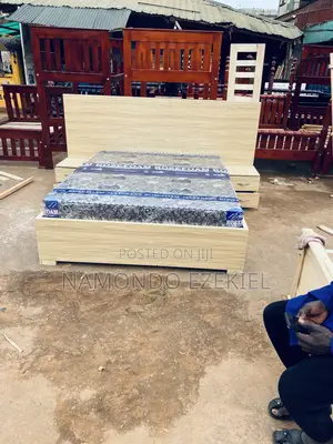 A Bed With Bedside Table and Mattress