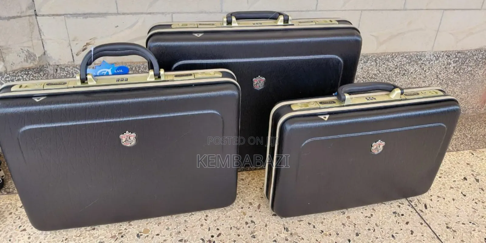 A Set of Three Black Hard-Shell Briefcases