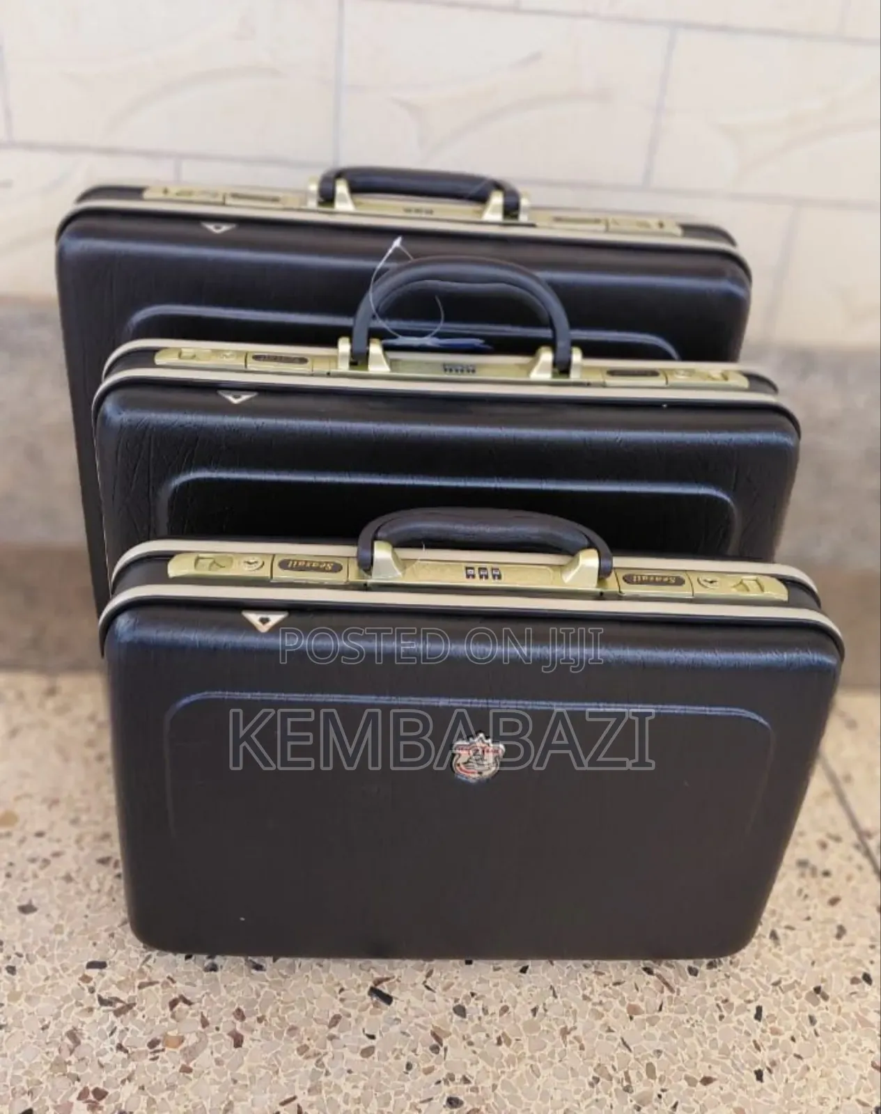A Set of Three Black Hard-Shell Briefcases