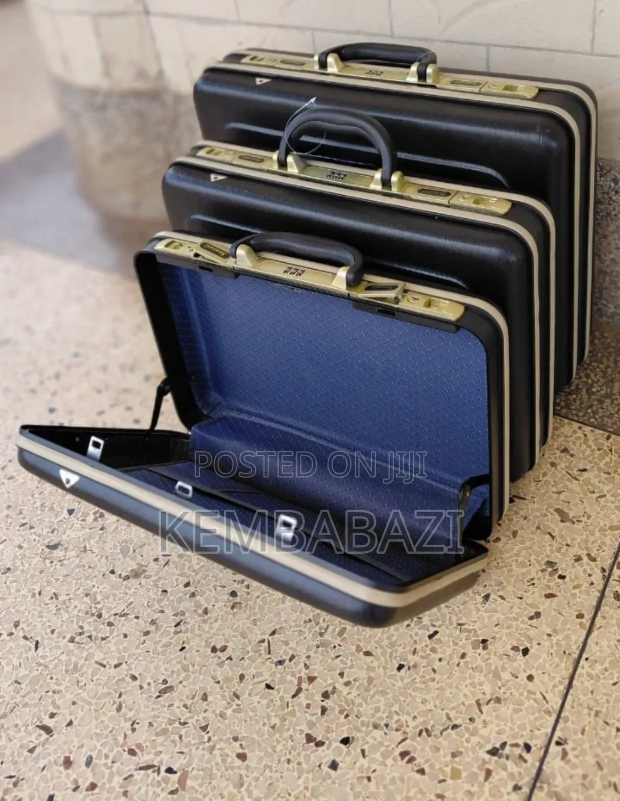 A Set of Three Black Hard-Shell Briefcases