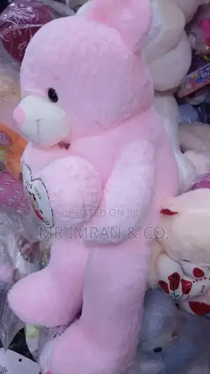 Large Pink Plush Teddy Bear Holding a Heart Pillow.