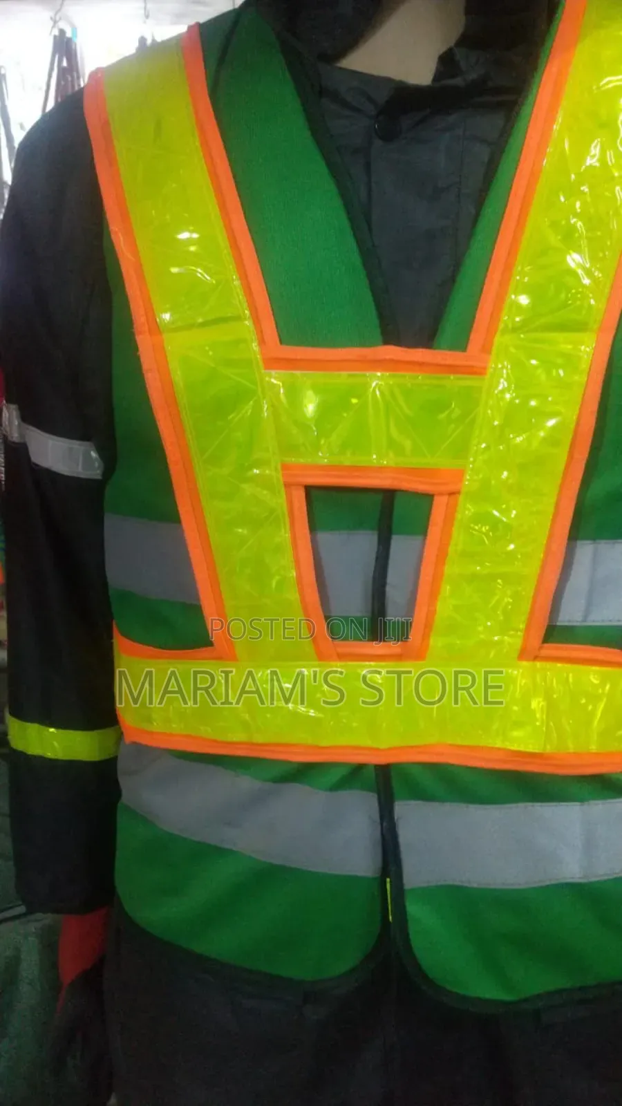 Green Safety Vests Featuring Fluorescent Orange Trim .