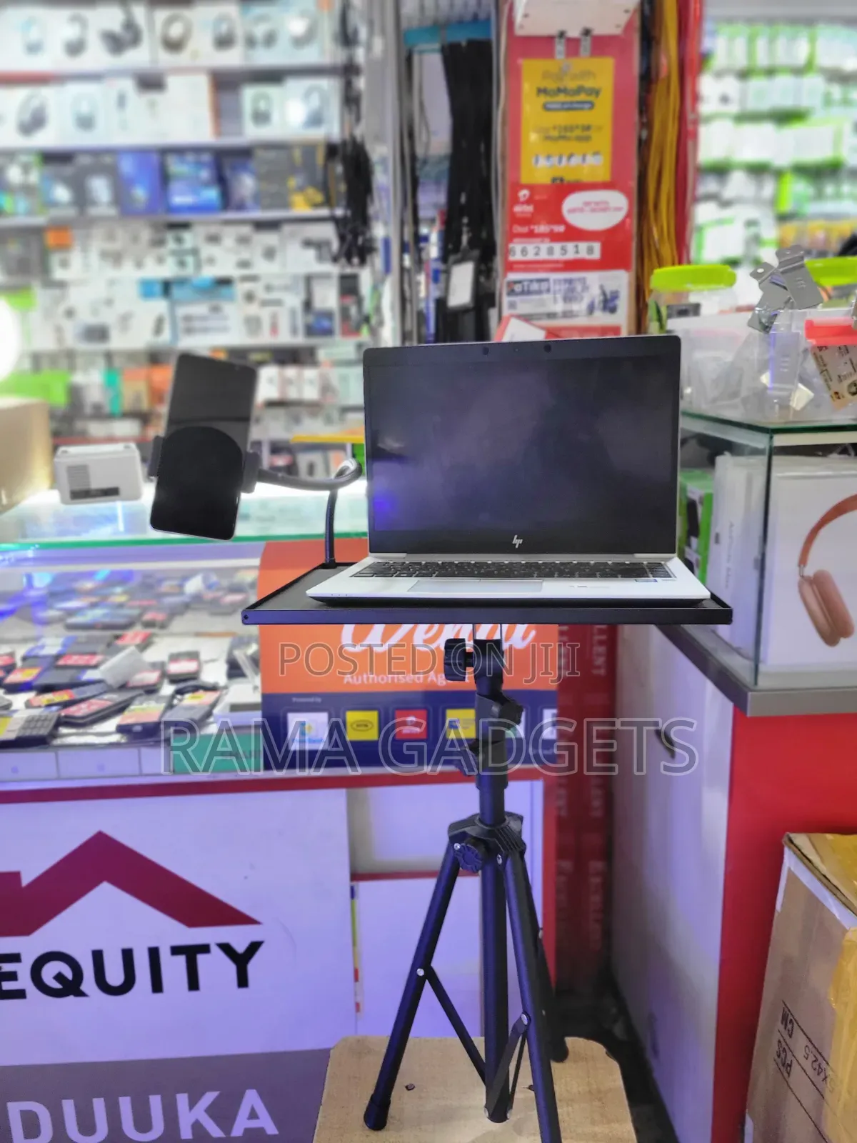 Laptop Stand With an Attached Phone Holder Mounted on a Tripod