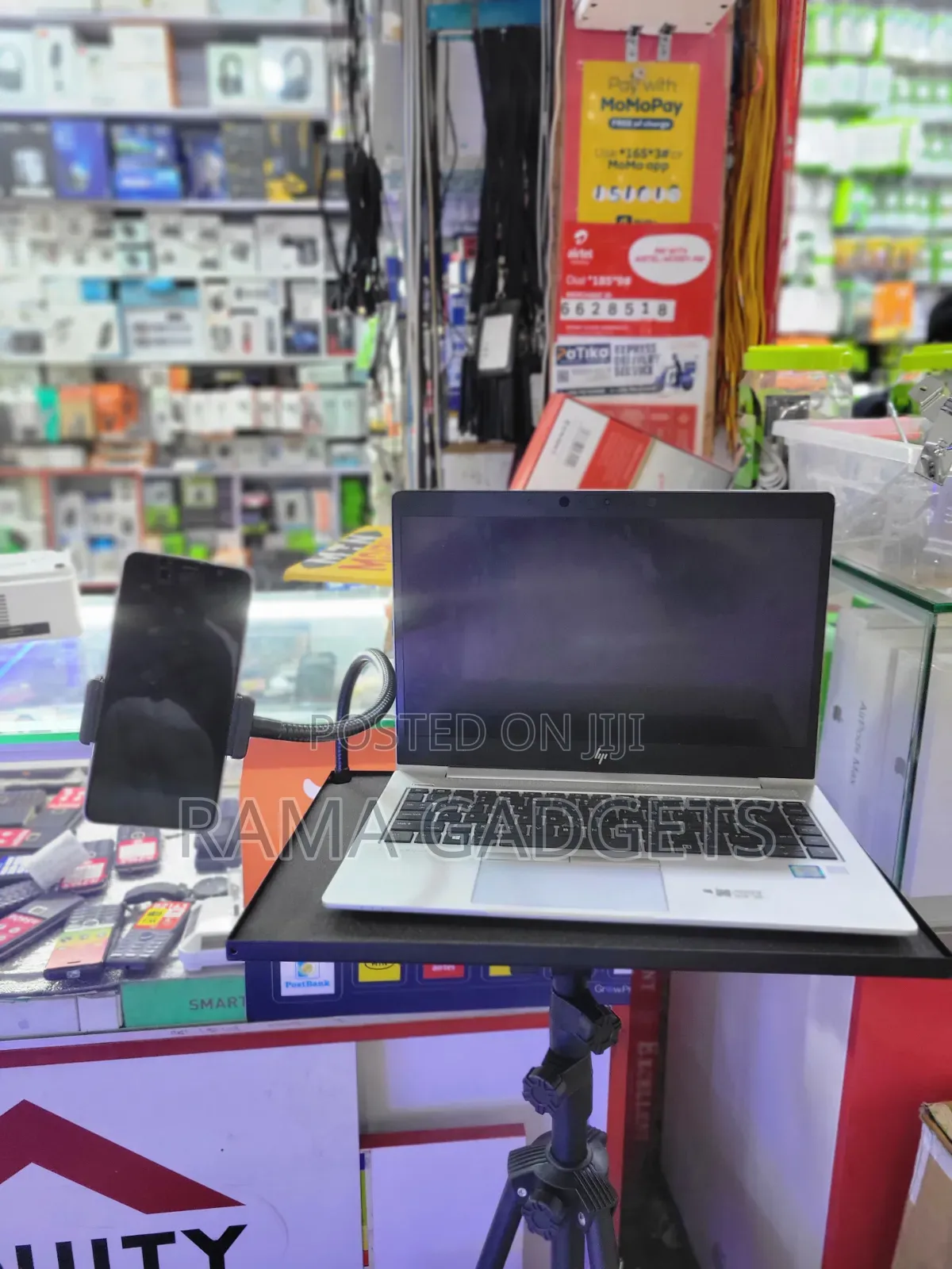 Laptop Stand With an Attached Phone Holder Mounted on a Tripod
