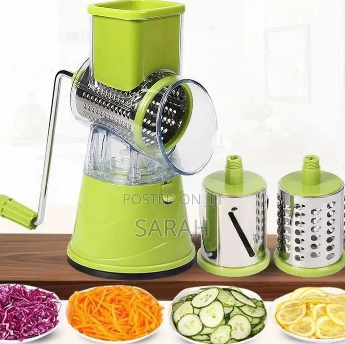 A Green Manual Tabletop Drum Grater And Vegetable Slicer.
