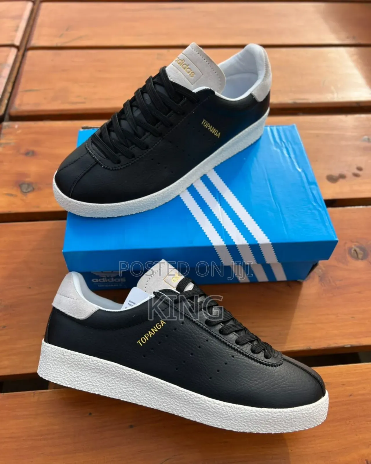 Black Adidas Topanga Sneakers With a White Textured Sole