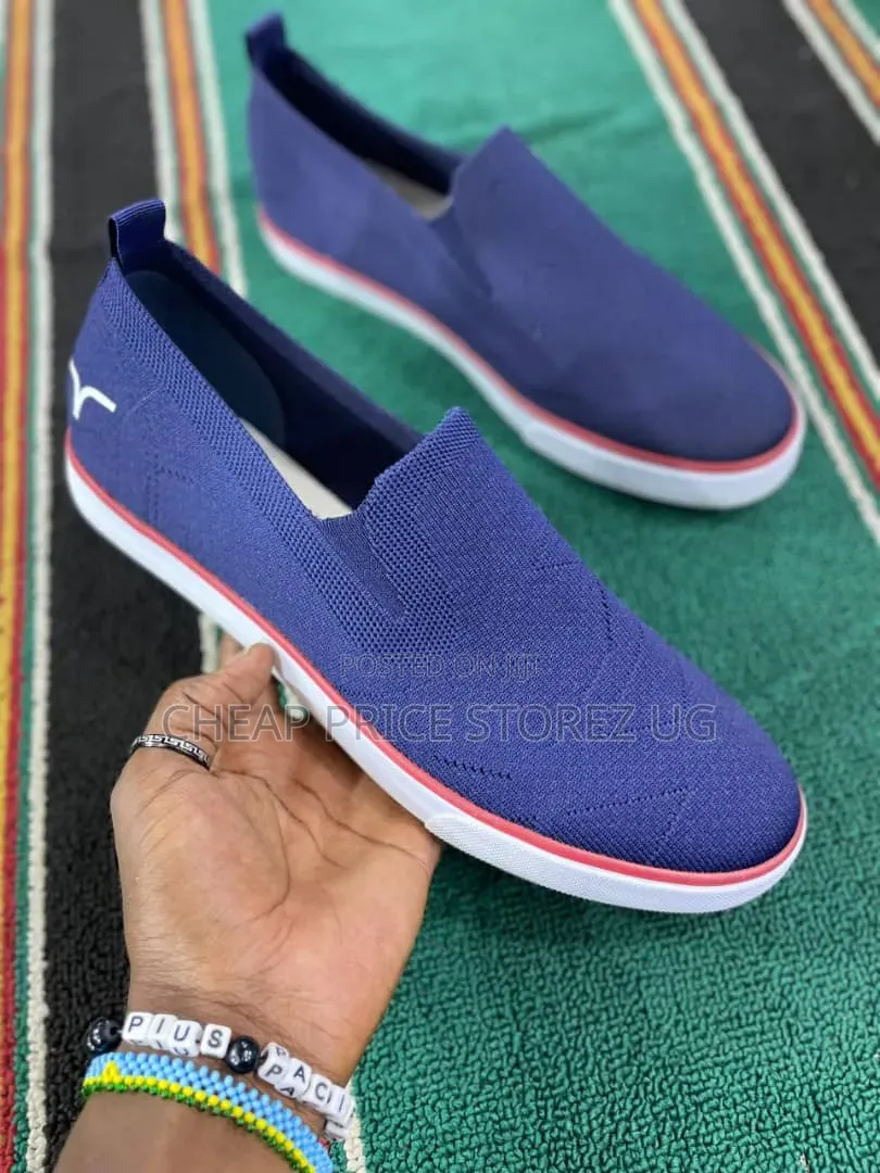 These Are Blue Slip-on Knit Sneakers Featuring a White Rubber