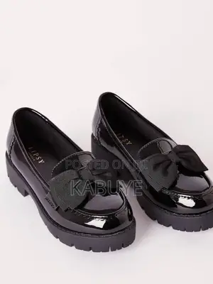 Stylish Black Patent Chunky Loafers Featuring a Prominent Bow.