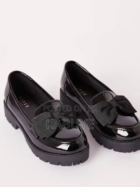 Stylish Black Patent Chunky Loafers Featuring a Prominent Bow.